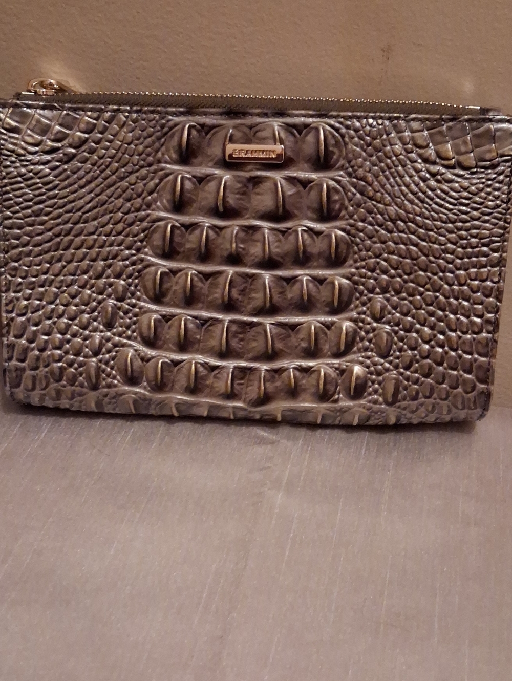 Brahmin Daisy leather wristlet.brown with gold hues.